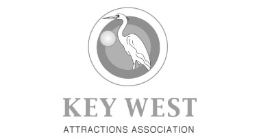 Logo for the Key West Attractions Assciation that features an egret imposed against several circles of different sizes