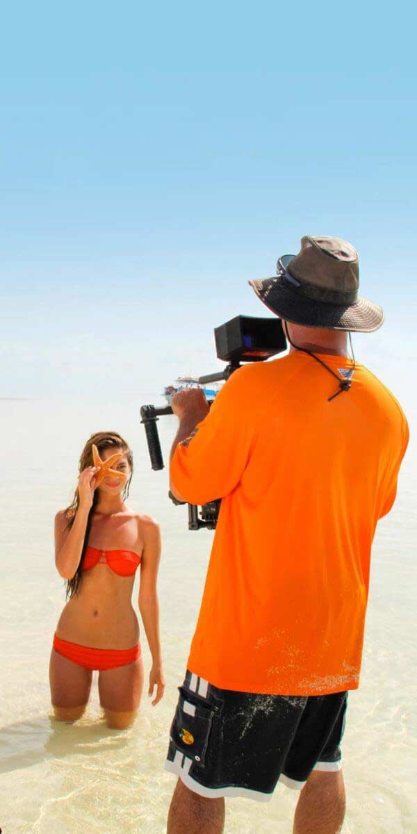 model with starfish being filmed by cameraman